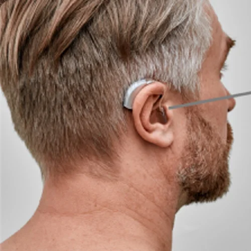 Man wearing a behind-the-ear hearing aid