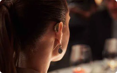 Woman wearing a receiver-in-canal hearing aid